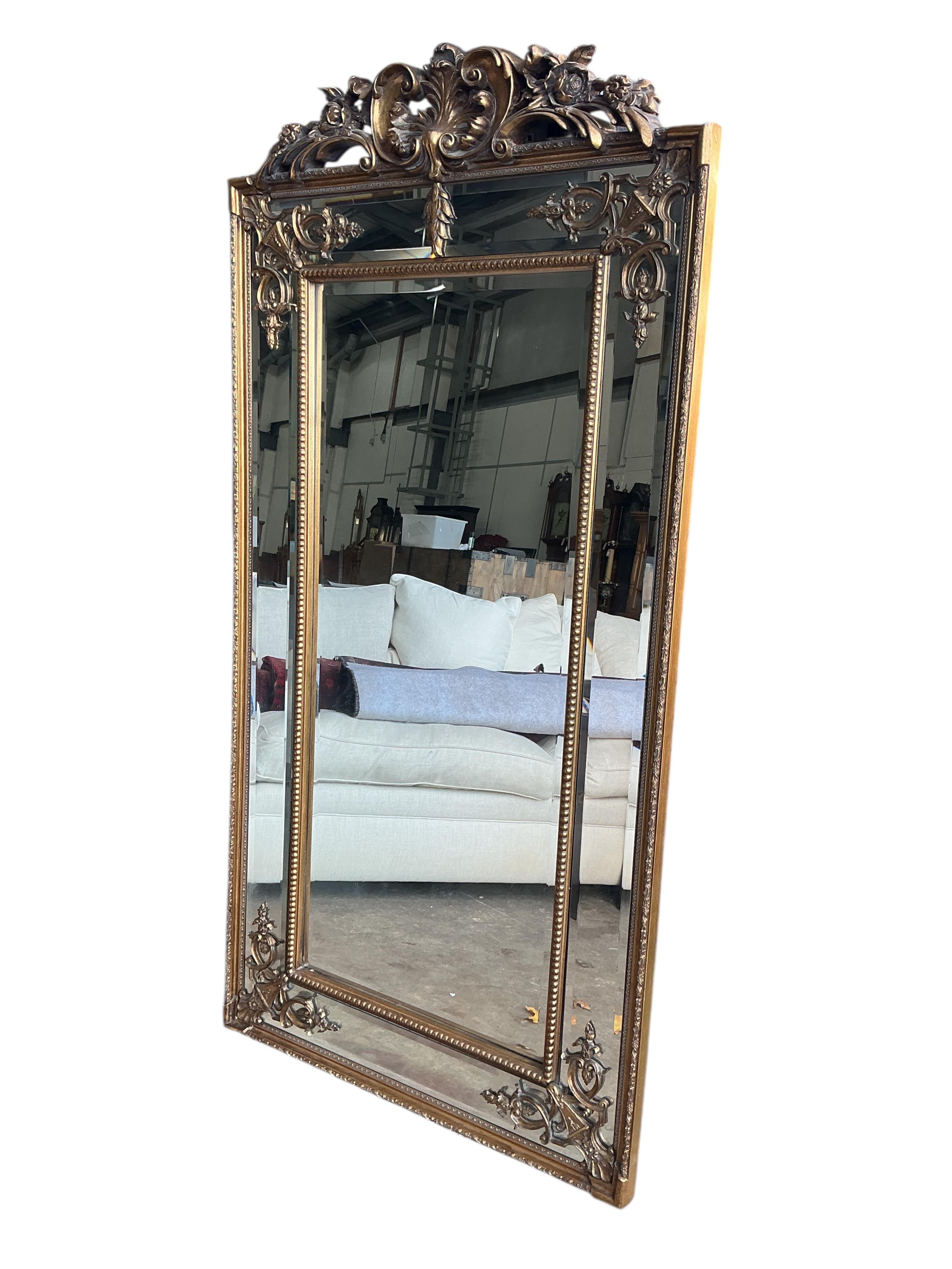 A reproduction Victorian style gilt composition overmantel mirror, width 91cm, height 184cm